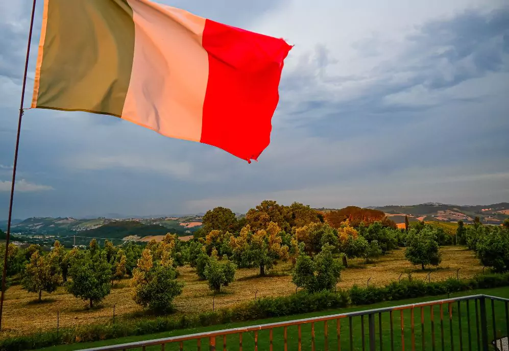 View over Marche region, with italian flag in foreground