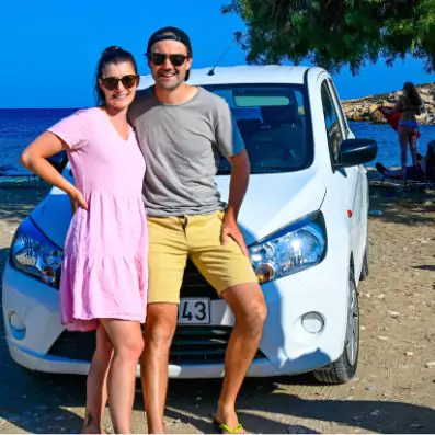 Tim and Eva on Greek Island Beach with hire car