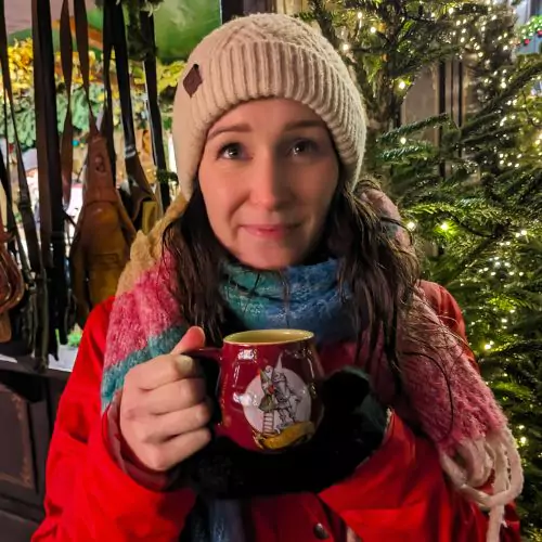 Eva posing with a warm Gluwein at Cologne Christmas Markets