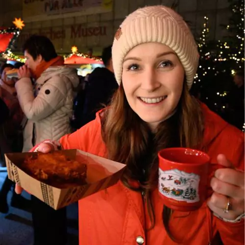 Eva showing of her gluwein and potato fritters at the Cologne Christmas Markets