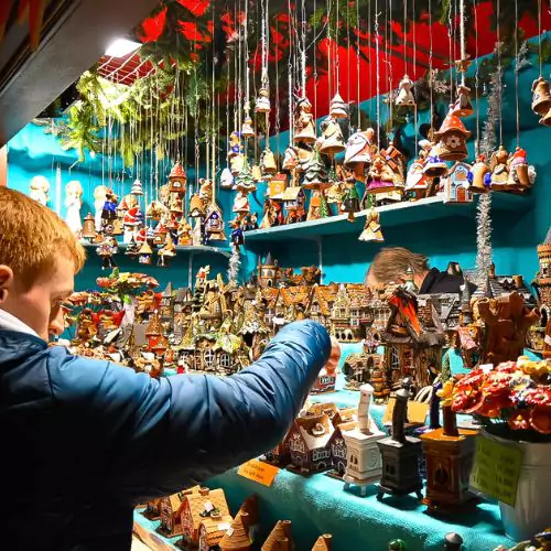 A stall at the Cologne Markets selling wooden house Christmas decorations