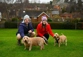 Couple sitting with two small dogs in Country, UK