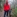 Woman in red jacket with German Sheppard dog in the rain