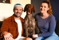 A couple on a couch posing with a German Short Haired Pointer