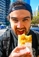 Man eating a famous borek from Victoria Markets