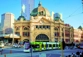 Flinders Station in Melbourne with a blurred Yarra Trams tram going past.