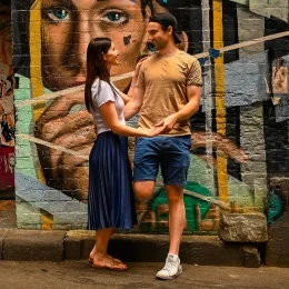 Couple leaning against a graffiti wall in Melbourne famous laneways