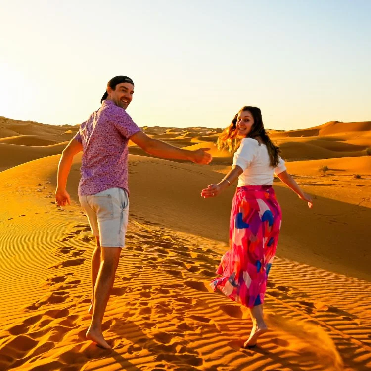 couple running in Sahara Desert